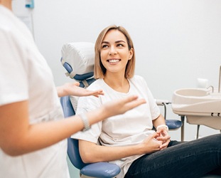Smiling female patient visiting her endodontist in Huntsville, AL