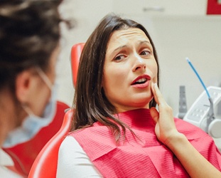 Woman with tooth pain about to receive root canal therapy in Huntsville, AL