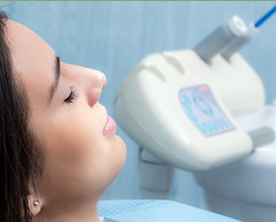 Woman with eyes closed in dental chair