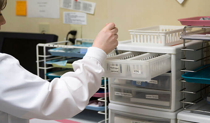 Team member storing dental lab materials