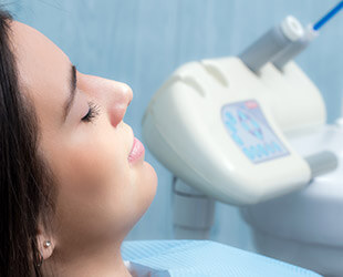 Relaxed patient eyes closed in dental chair