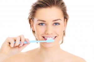 woman smiling, woman brushing her teeth, brushing teeth