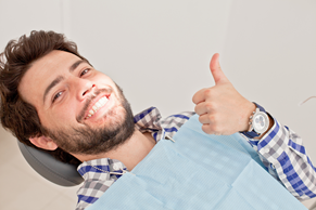 Man giving thumbs up at dentist