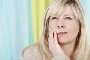 woman blonde severe tooth pain