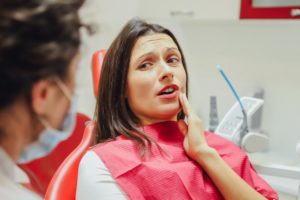 person talking to a dentist about a toothache