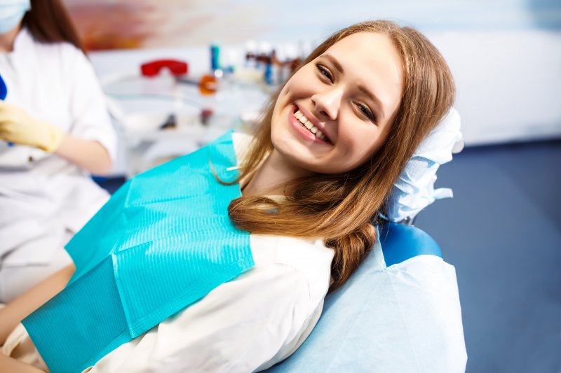 Woman smiling after completing root canal treatment