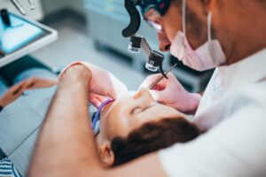 Dentist performing root canal. 